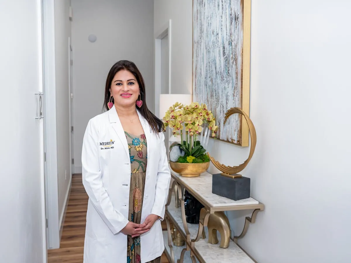 Dr. Haritha Mikkilineni, MD, in her white coat at the Medrein clinic