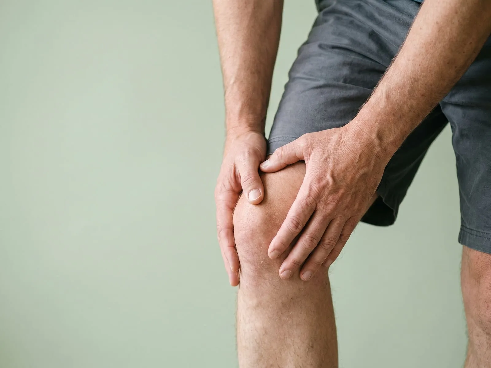 Clinician preparing a subcutaneous regenerative peptide injection near a patient's knee at Medrein Health in Southlake, TX